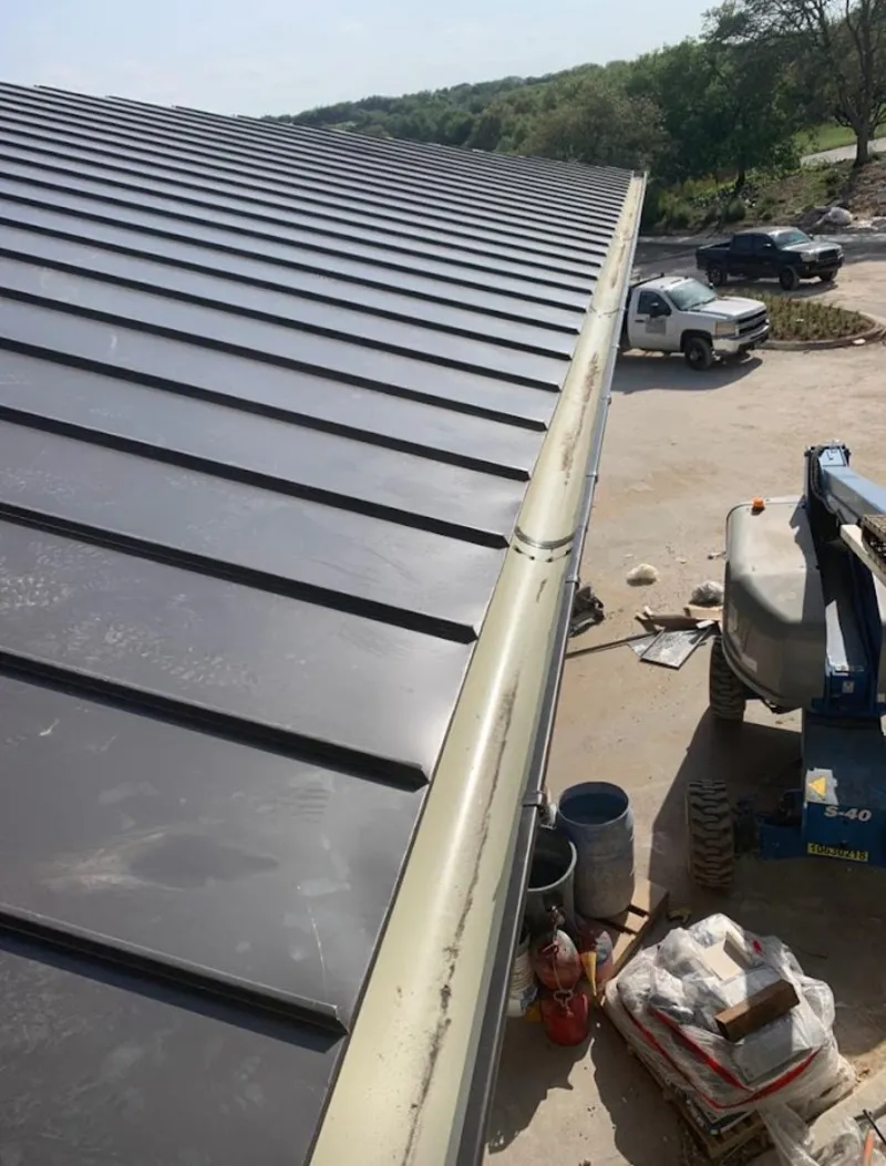 Standing seam panel and gutter detail on a metal roofing jobsite in Linthicum